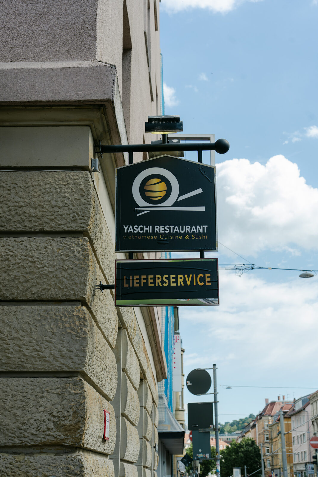 Außenschild des Yaschi Restaurant mit Lieferservice-Hinweis